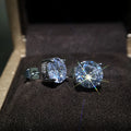 Women's round white zircon stud earrings with copper geometric round shape on display