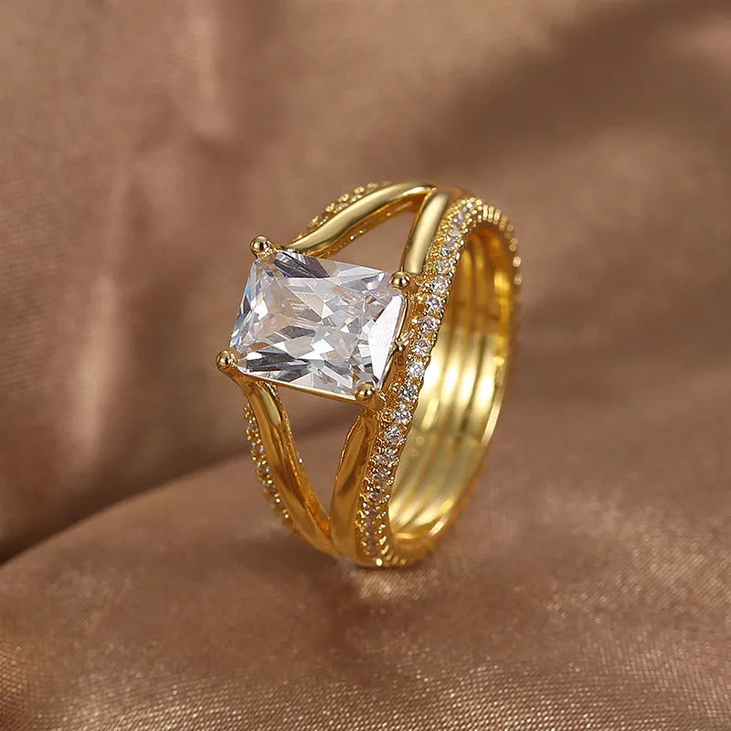 Women's geometric gold ring with square zircon centrepiece showing clean lines and electroplated finish