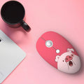 Wireless cartoon animal mouse in blue rabbit design with USB receiver beside laptop