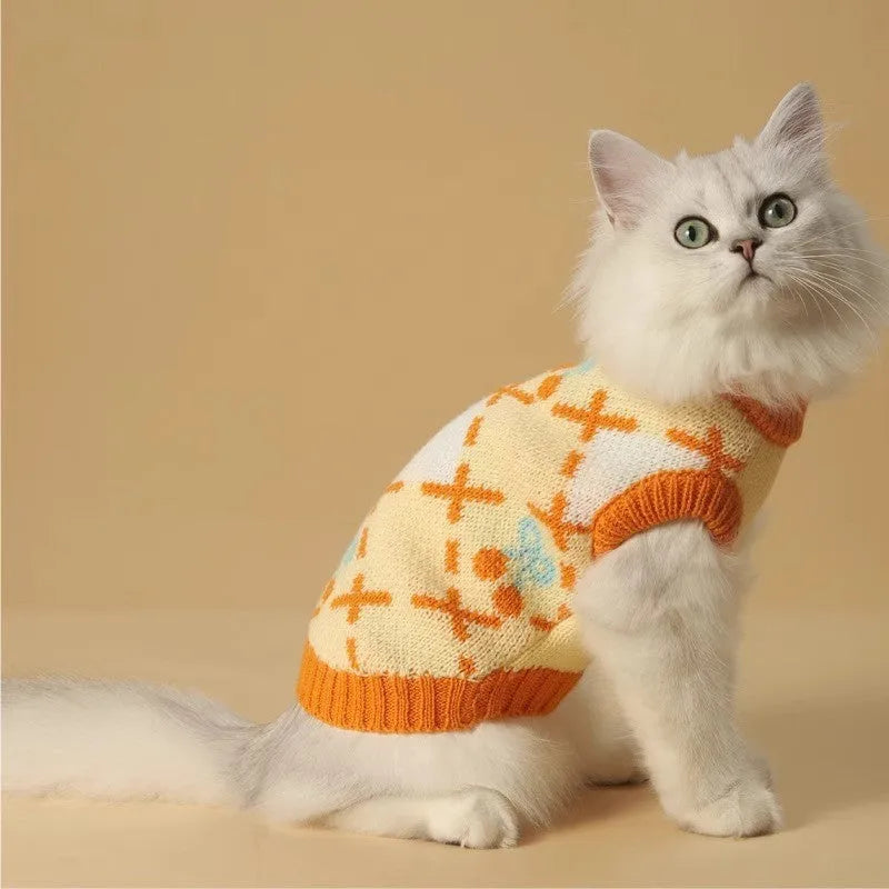 Orange diamond knit cat jumper showing chest measurement points and size labels