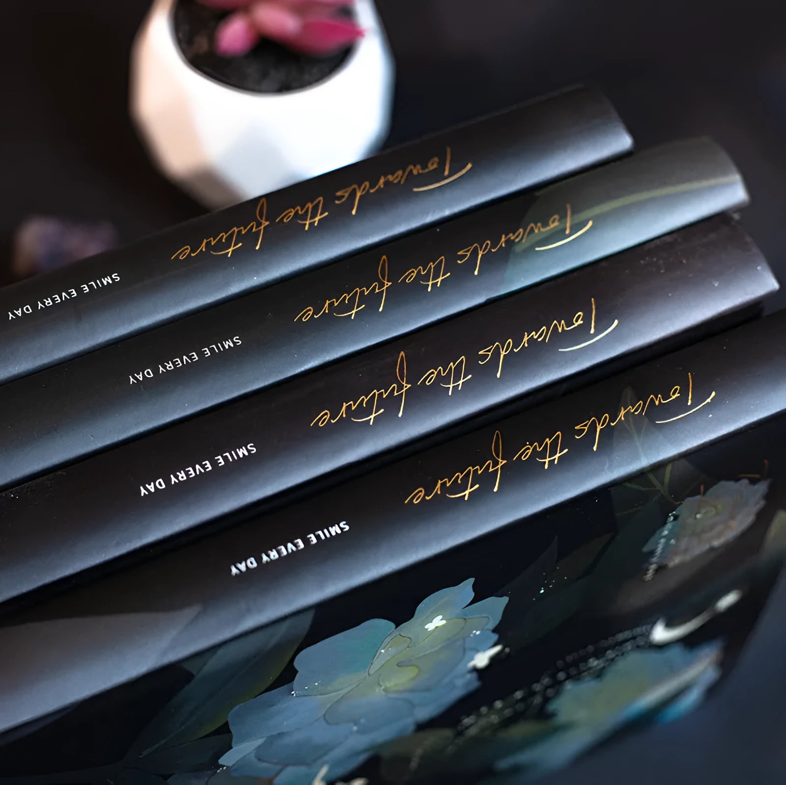 A5 hardback notebook with luminous cover open to show colour illustrated pages.