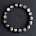 Natural obsidian crater ball bracelet in silver or gold finish, showing textured bead detail.