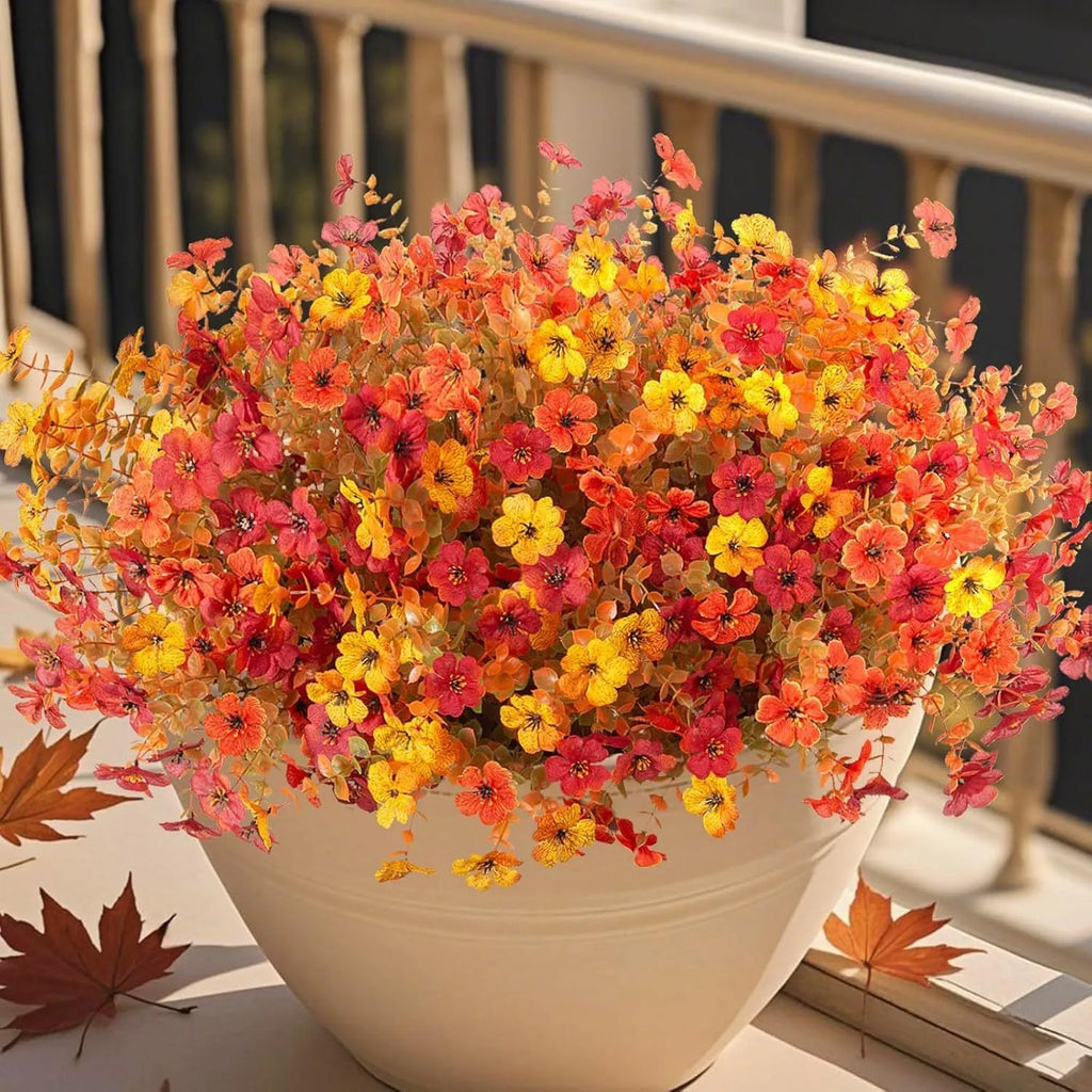 Artificial flower bouquet with autumn orange, red, and yellow silk flowers on plastic stems for decoration