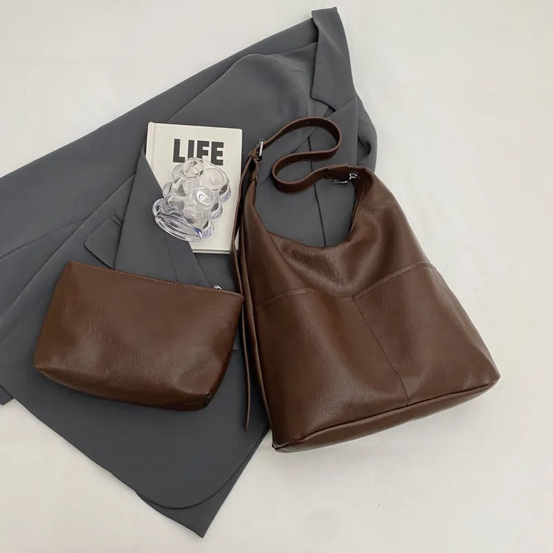 Women's large-capacity shoulder bag in soft PVC with bucket shape and stitching detail, available in black, coffee, brown, mud, beige