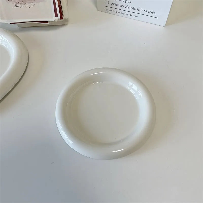 White porcelain plate with doodle design, shown in round and bear shapes, small and large sizes.