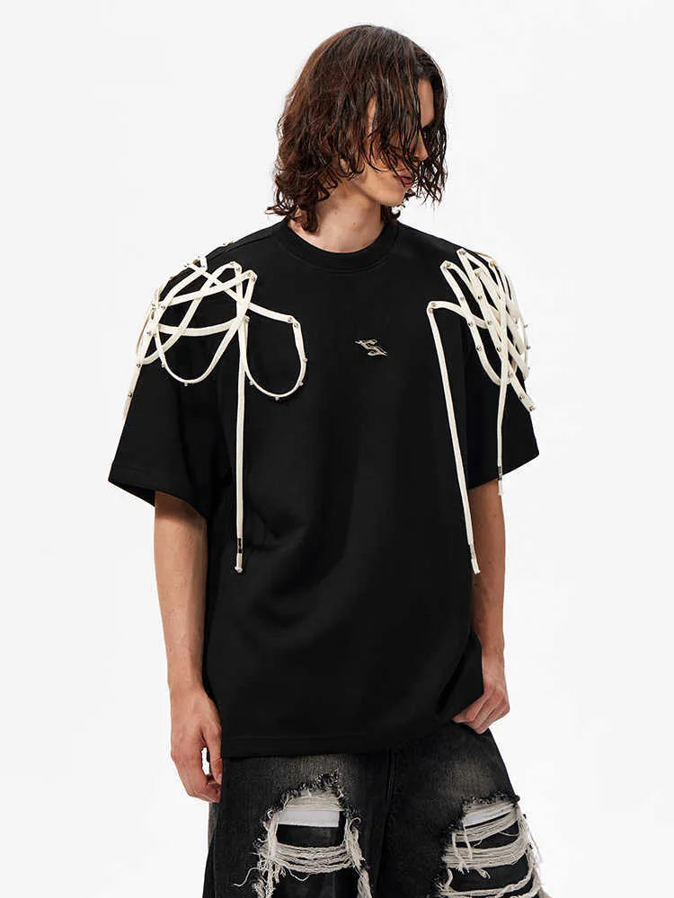 Black loose fit short sleeve t-shirt with padded shoulders and decorative rivet ribbon detail.