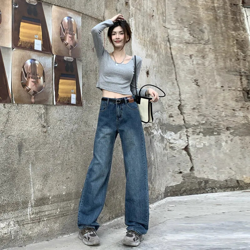 Woman wearing retro blue high-waisted straight-leg jeans in a cotton denim fabric.