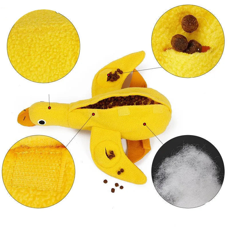 Yellow rubber duck dog toy with squeaker and treat compartment for puppy training and teething.