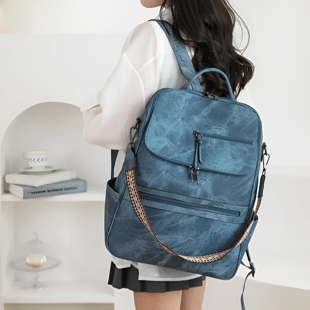 PU leather college backpack with curved shoulder strap in solid colour with stitching detail.