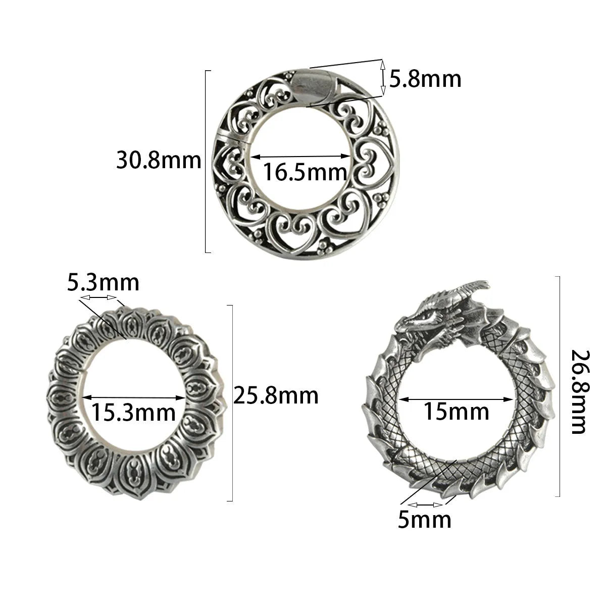 Pair of large antique silver dragon-shaped geometric ear cuffs with hollow-out detail on a plain background.