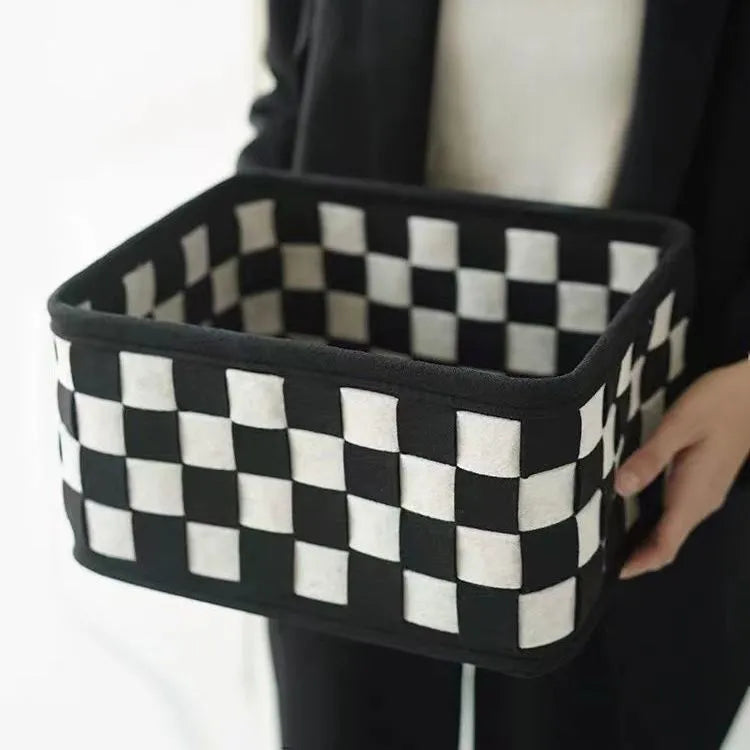Checkerboard patterned grey felt folding storage basket with dimensions 37cm by 29cm.