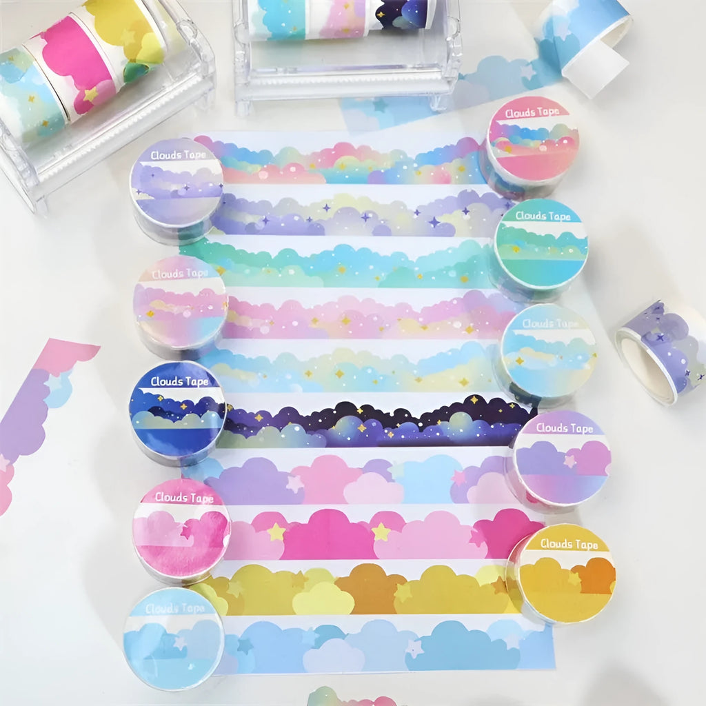 Roll of decorative washi tape with white stars and clouds pattern on a light blue background.