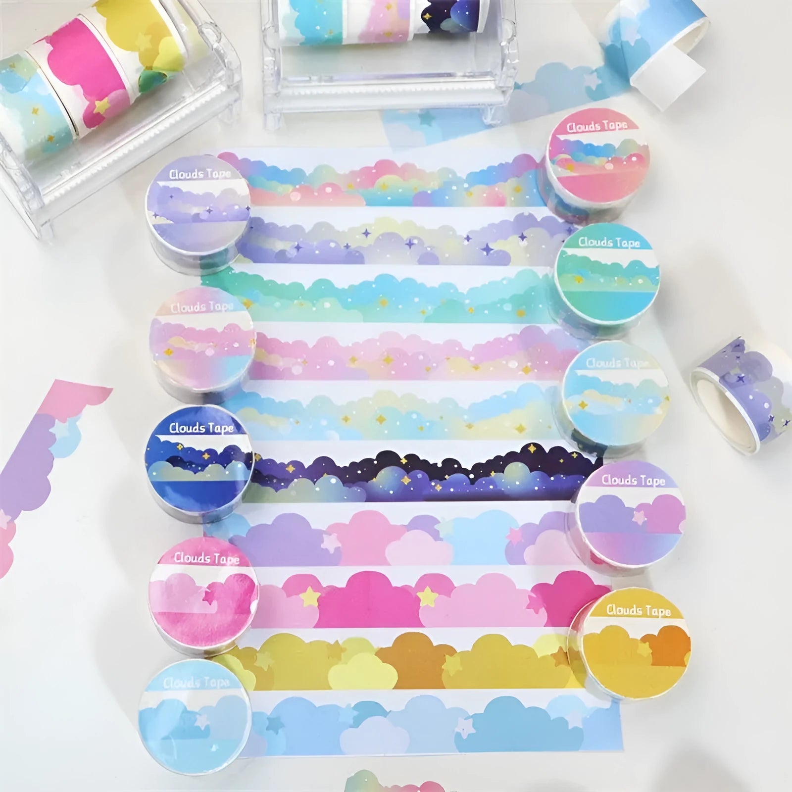 Roll of decorative washi tape with white stars and clouds pattern on a light blue background.