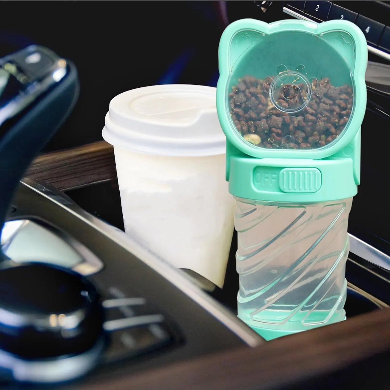 Green 3-in-1 portable pet water bottle with food container and poop bag dispenser, shown with carrying strap.