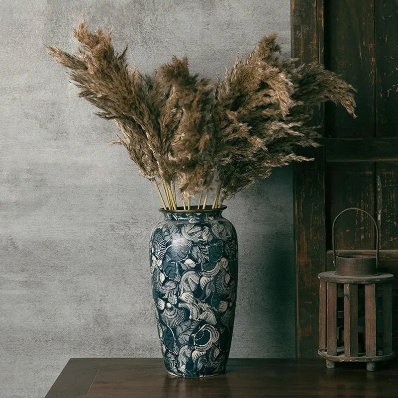 New Chinese retro artistic ceramic vase with dried flowers on a tabletop in a home living room setting