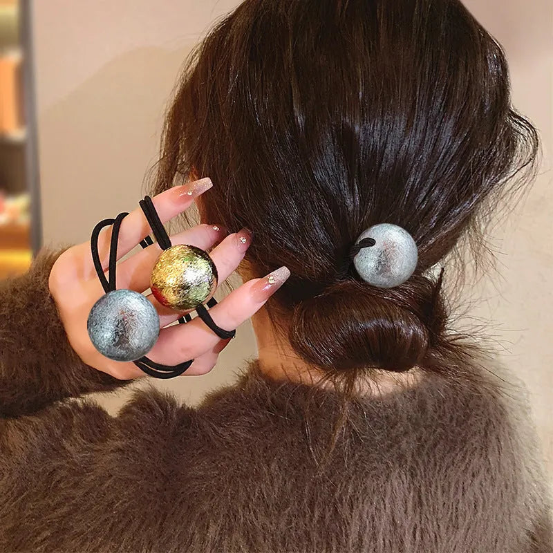 Resin hair band headdress with electroplated gold finish, round head rope style on a white background