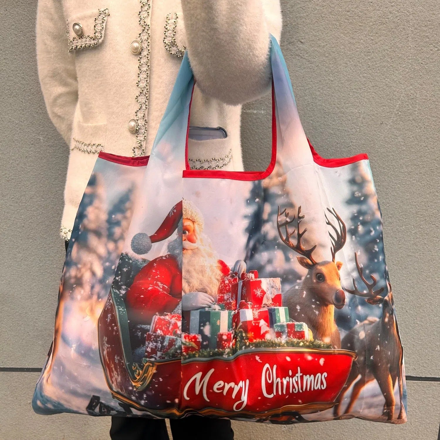 Large one-shoulder polyester Santa Claus gift bag with festive red and white design