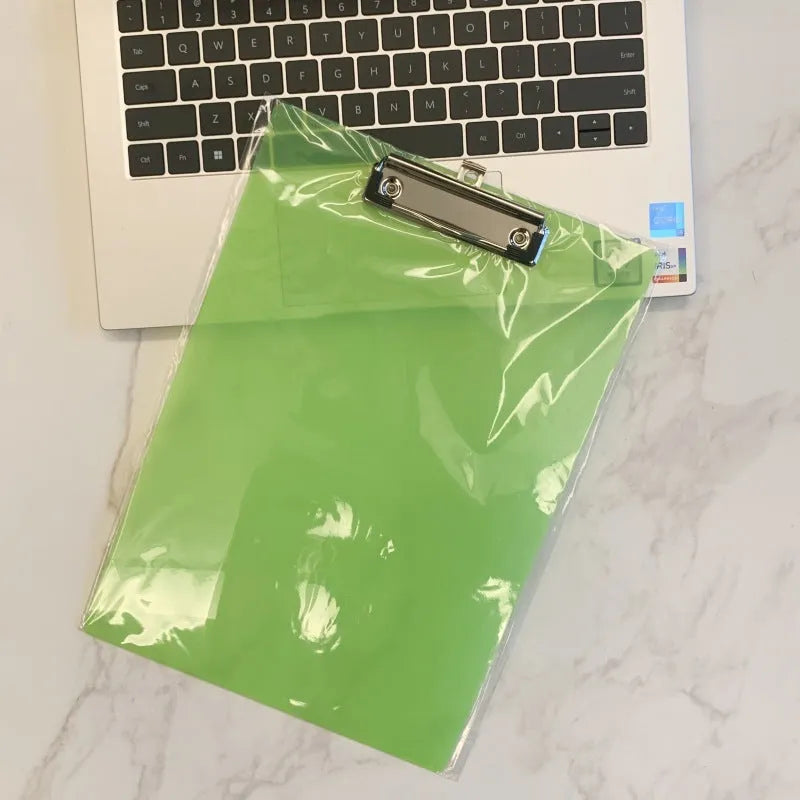 Clear plastic A4 plate holder with metal clip showing document inside, available in blue, green, red and white colours