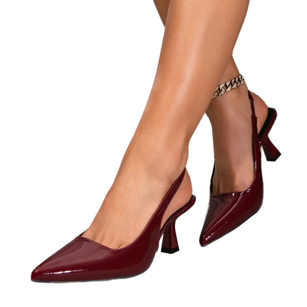 Wine red stiletto heel pointed toe closed toe sandals with elastic band on a plain background