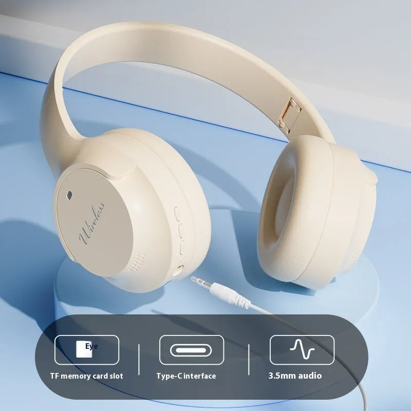Wireless Bluetooth headset in beige with head-mounted design and ear cups, neutral background