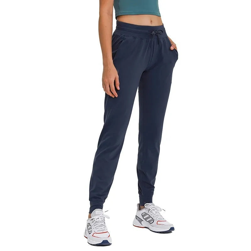 Women's high-waist yoga pants with a drawstring waist in a blue colour, laid flat.