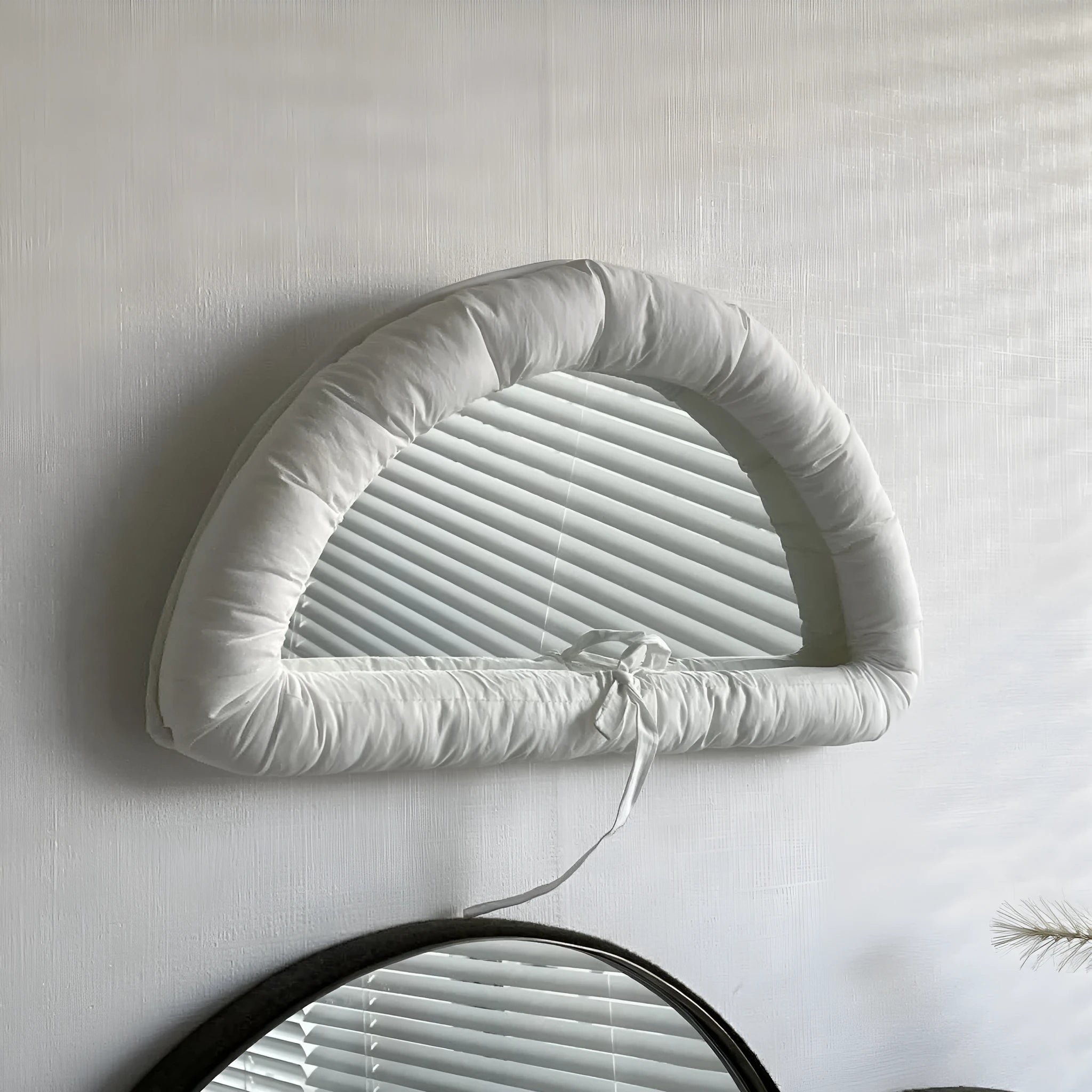 Soft rectangular fabric mirror panel in sapphire blue with a padded texture, shown hanging.