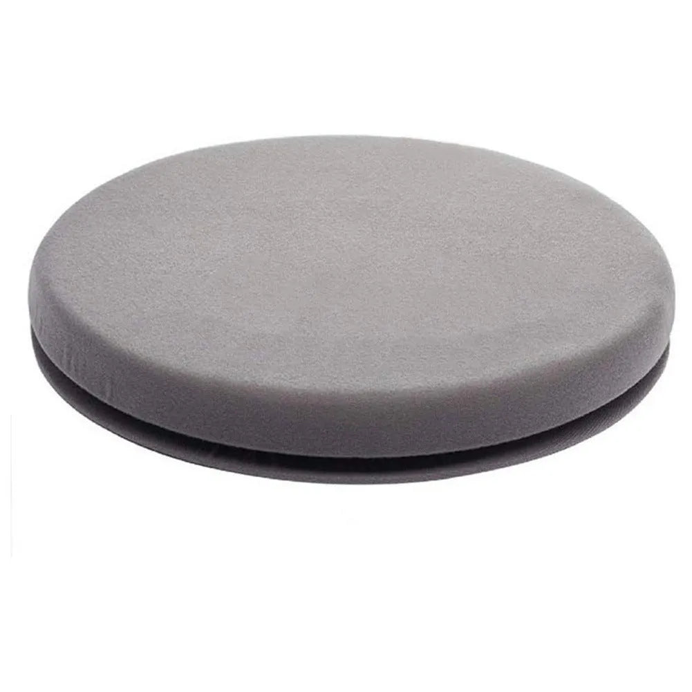 A grey 360-degree rotating car seat cushion on a car seat, showing its non-slip base and plush fabric cover.
