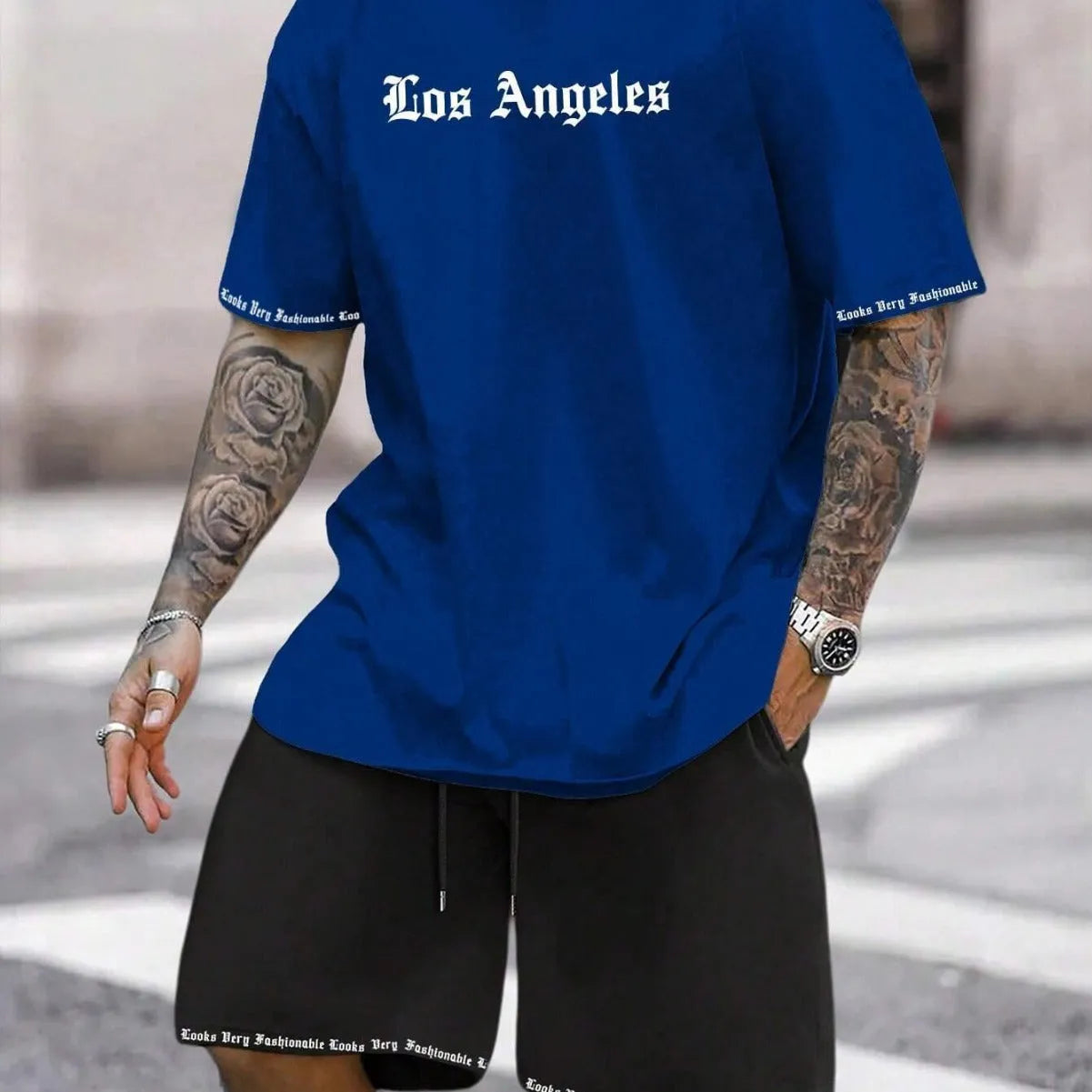 Man wearing a grey short-sleeved sports top and matching shorts from a quick-dry two-piece set.