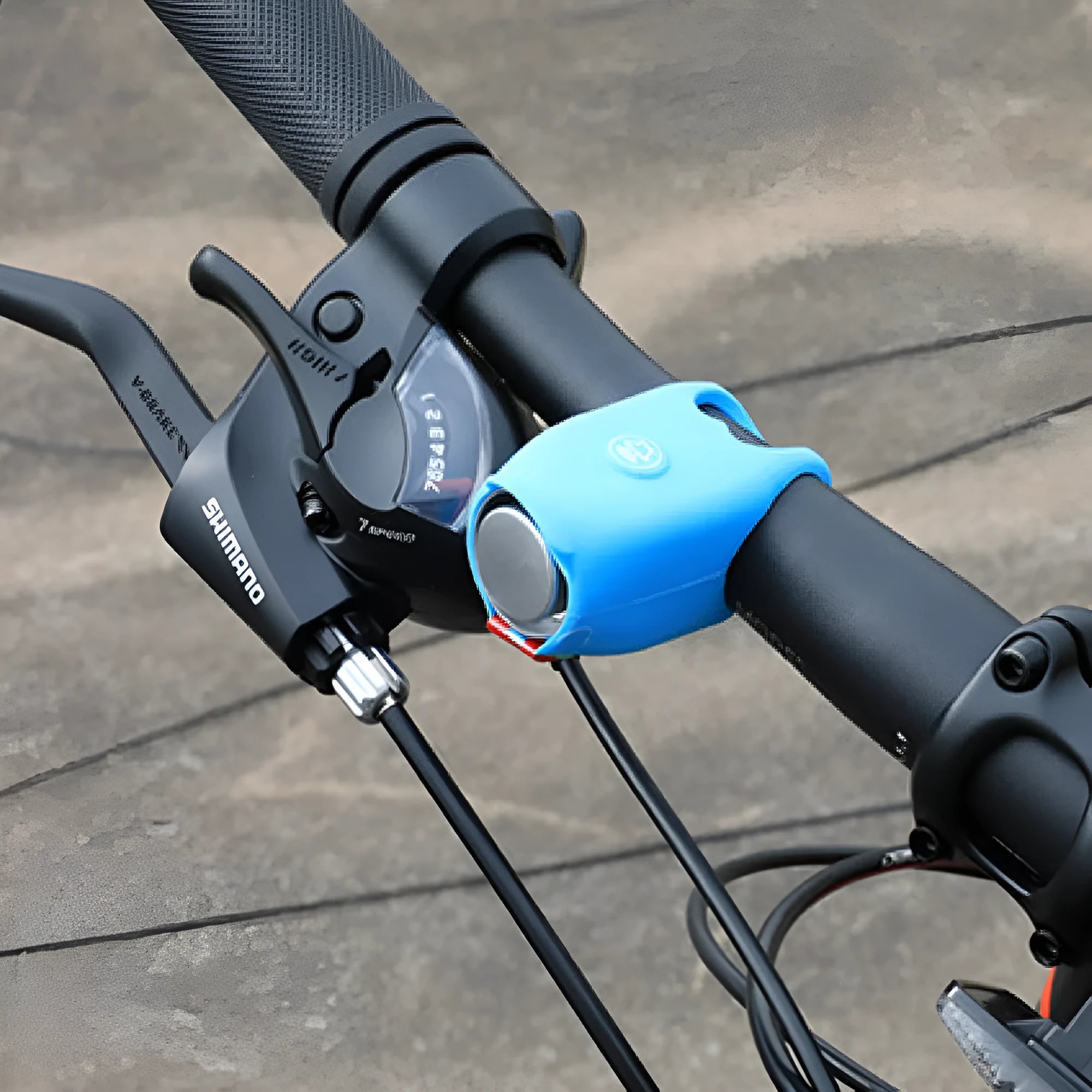 A plastic bicycle electronic horn in a choice of colours, showing handlebar mounting and two button cell batteries.