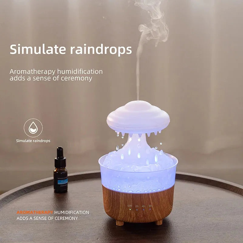 Wood grain white column-shaped rain cloud humidifier diffuser with LED night light on a table.