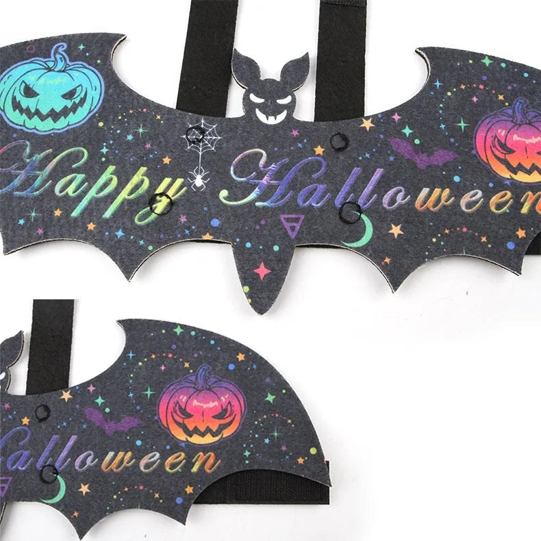 Halloween costume for a cat shaped like black bat wings, shown in orange pumpkin variant.
