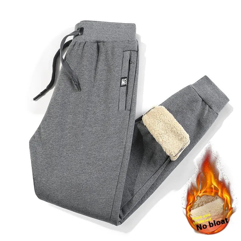 Man wearing grey fleece-lined cotton track pants with an elastic mid waist.