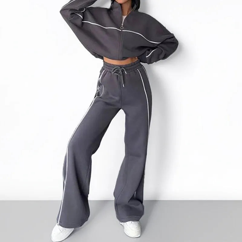 Casual polyester suit set showing a long sleeve mock neck hoodie and striped trousers on a model.