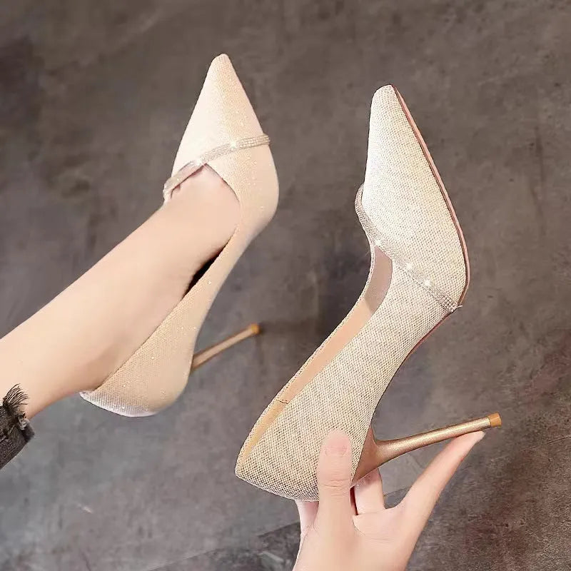 Women's gold stiletto court shoes with pointed toe and 9cm heel on white background