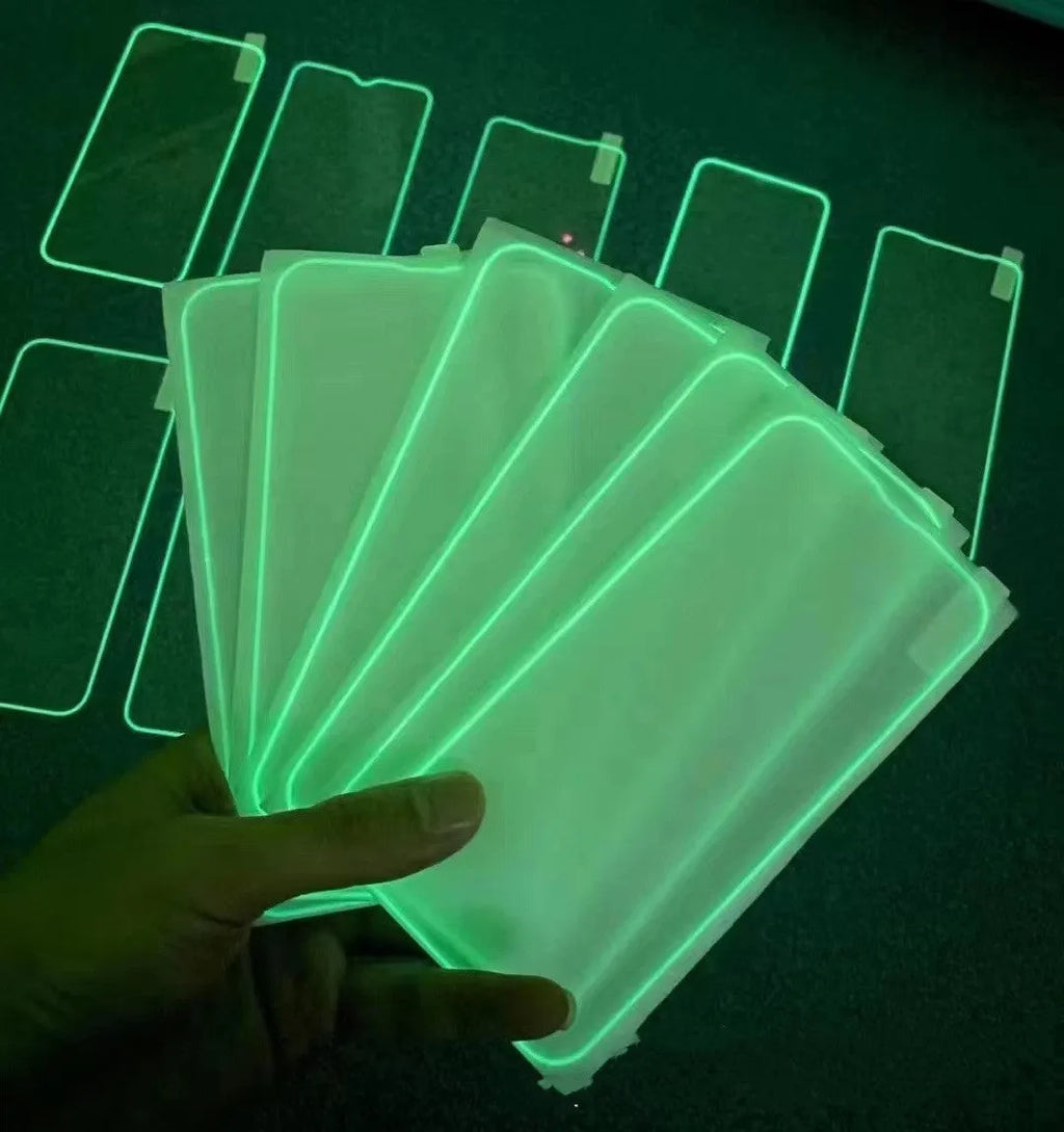 Fluorescent pink tempered glass screen protector fitted on an iPhone 13, showing full-screen coverage and luminous glow.