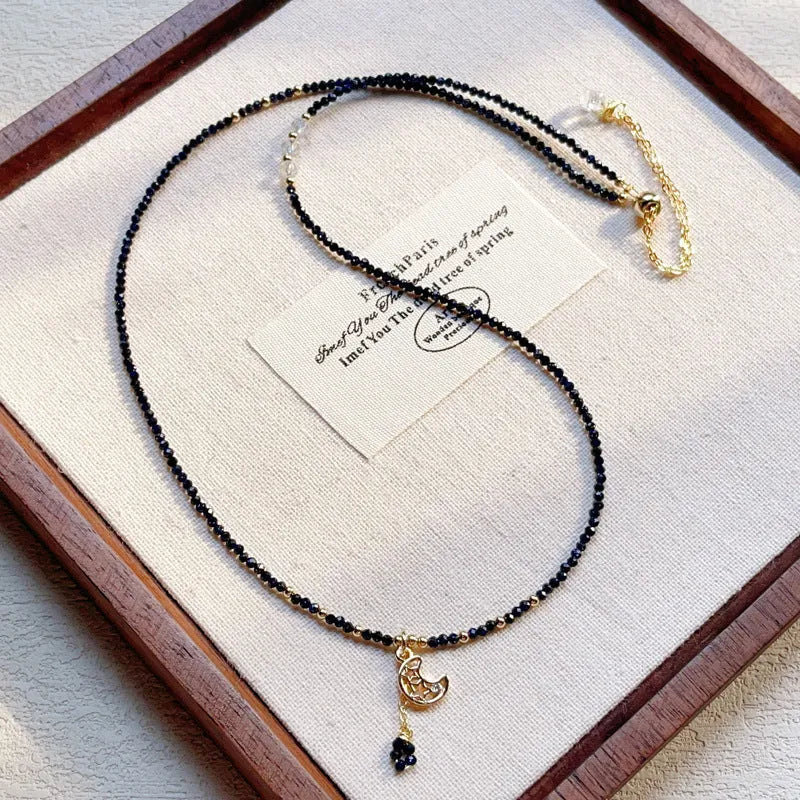 Close-up of a women's multi-layer blue sand bracelet with a three-ring design and gold sand stone cut.