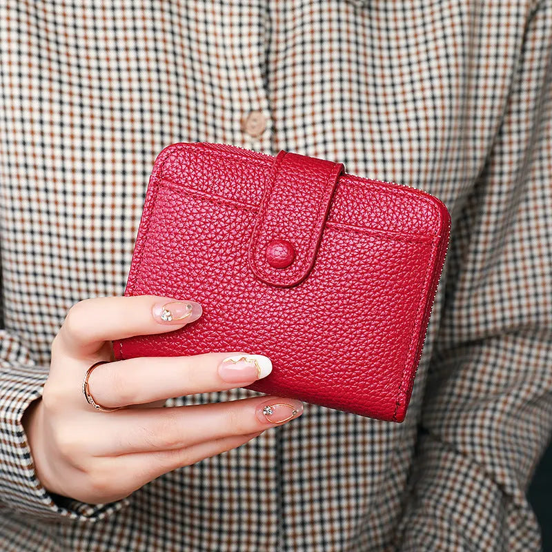 Women's lychee pattern short wallet in PU leather with antibacterial lining shown in beige, pink, black, and red colour options