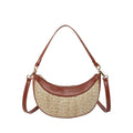 Hard structured straw dumpling shaped women's crossbody shoulder bag in black, shown with interior phone pocket.