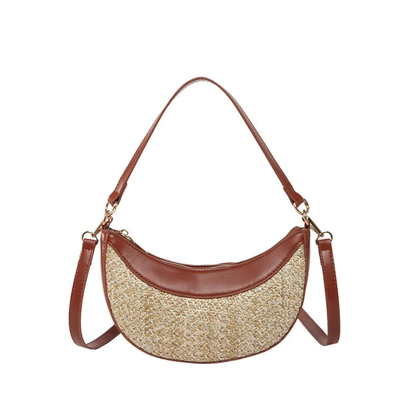 Hard structured straw dumpling shaped women's crossbody shoulder bag in black, shown with interior phone pocket.