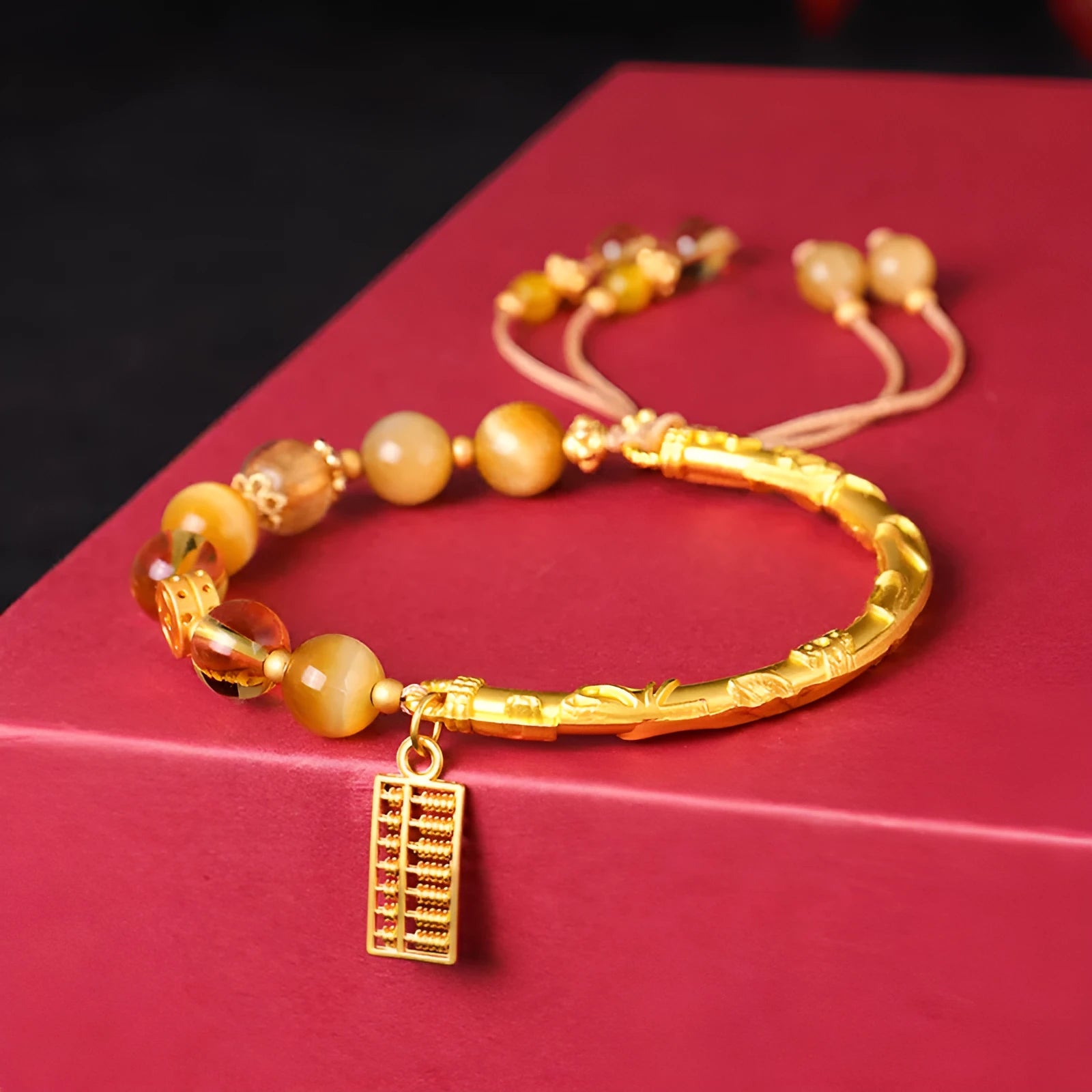 Handmade beaded bracelet with tigereye, citrine stones, and diamond-shaped abacus tag charm