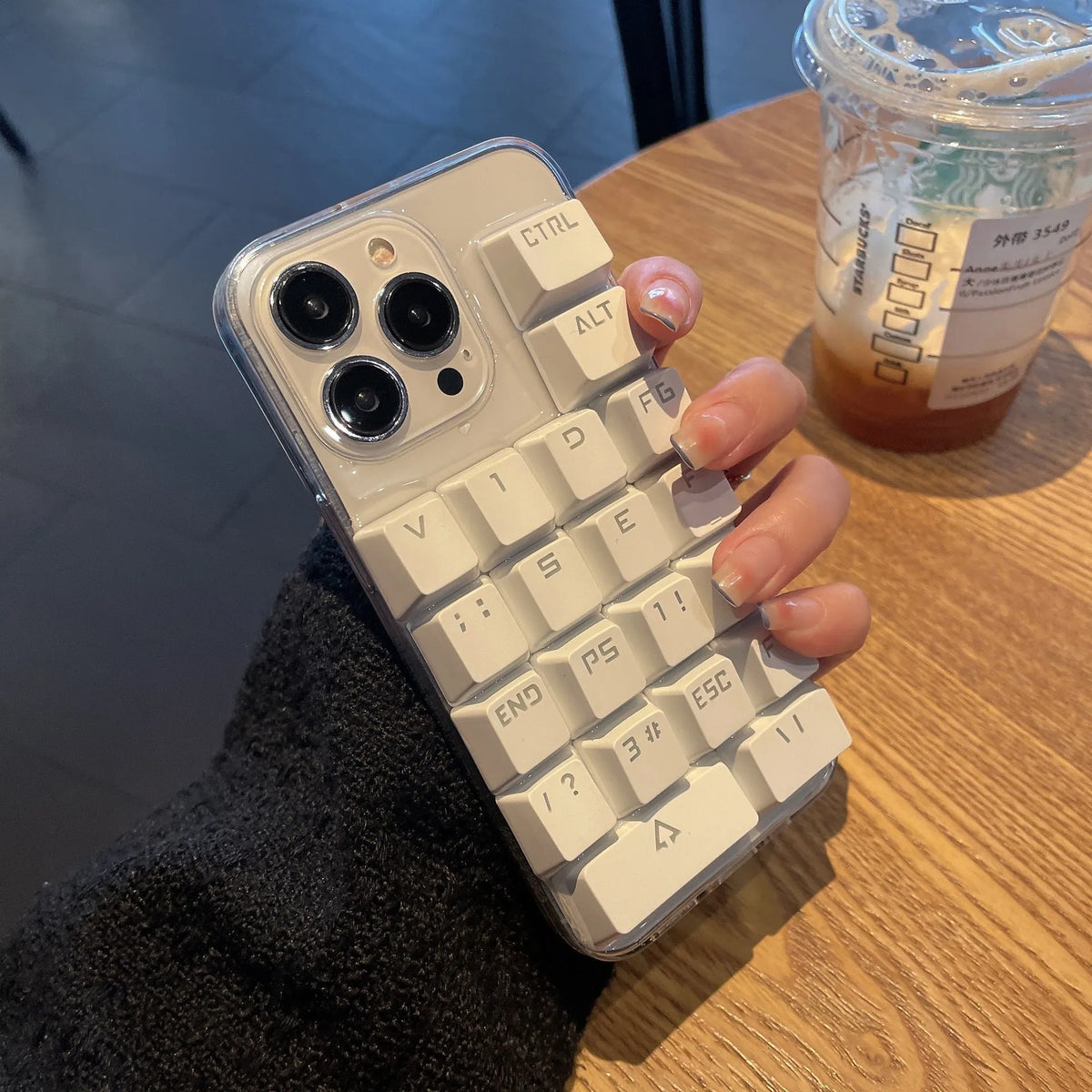 Creative keyboard mobile phone case with dripping glue material in keyboard colour, back cover type for Apple iPhone models.