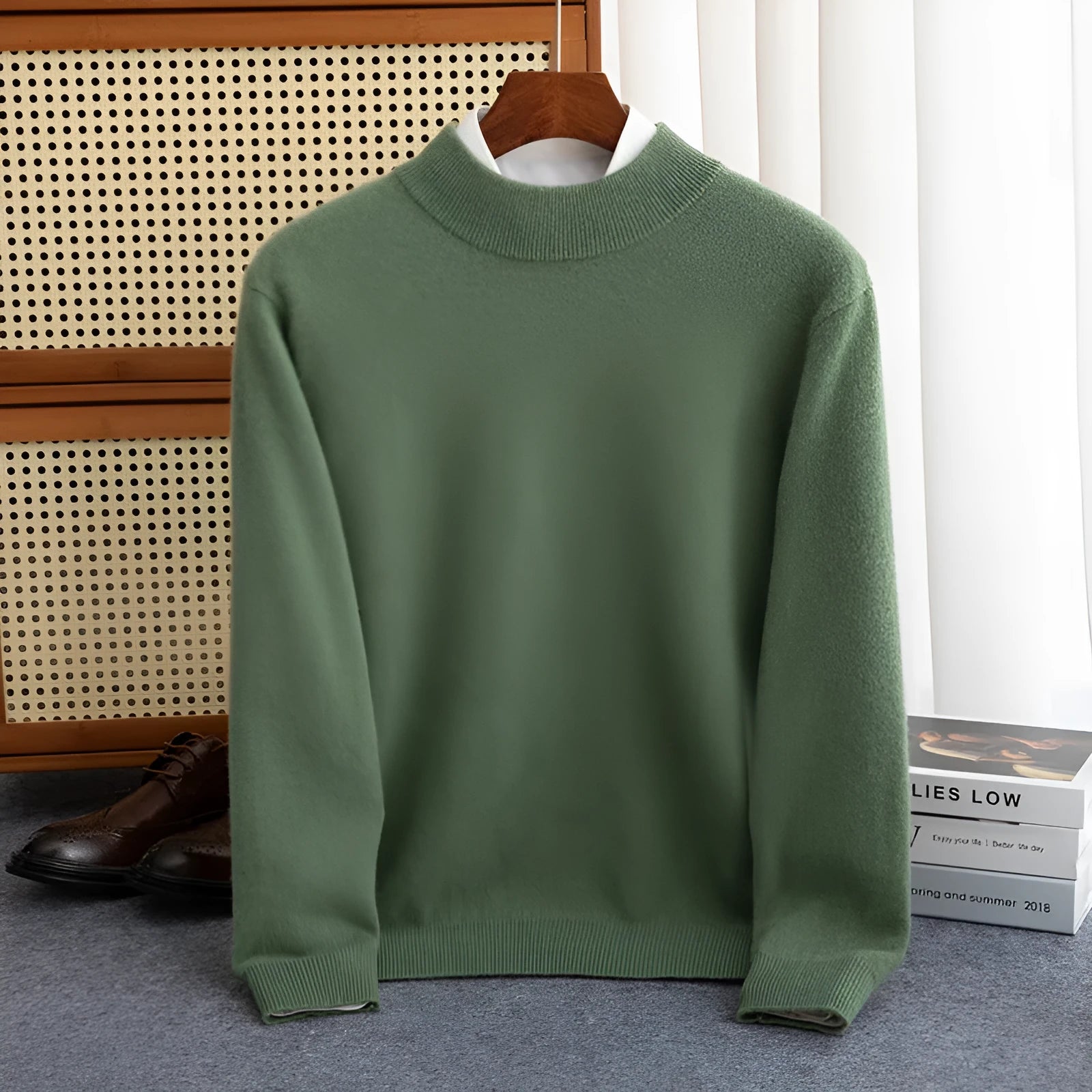 Man wearing a loose fit half-turtleneck wool sweater in a camel colour.
