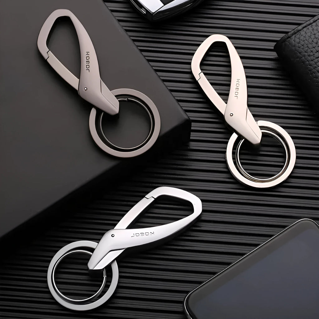 Black zinc alloy rectangular key chain with a carabiner clip and double ring, shown next to a set of keys for scale.