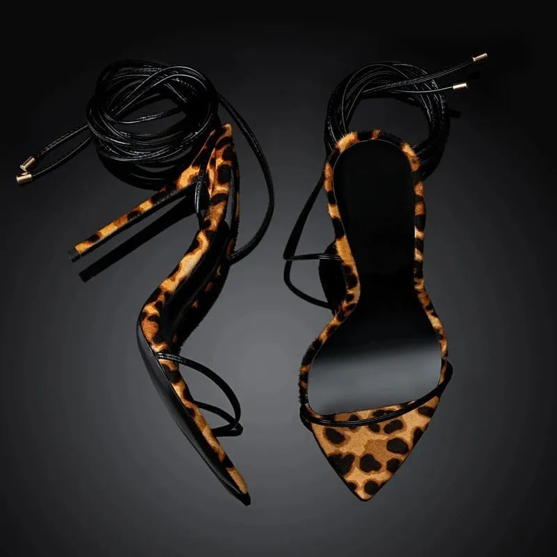 Women's leopard print Roman sandals with pointed toe and buckle fastening on a rubber sole.