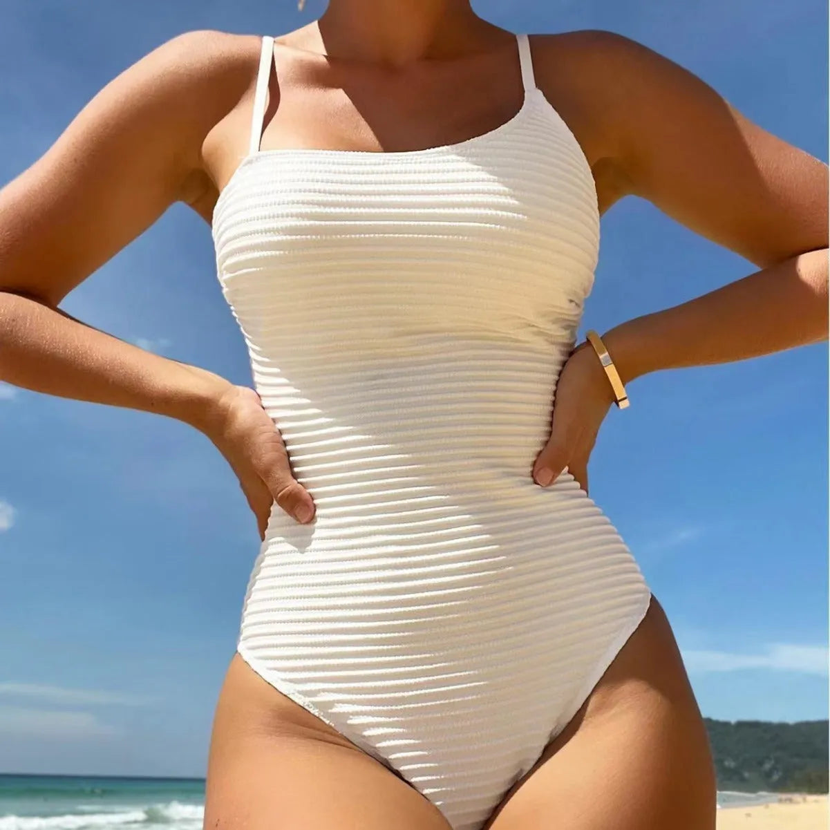Solid colour one-piece swimsuit with spaghetti straps on a mannequin.