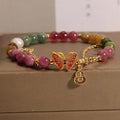 Natural jade coloured agate bracelet with butterfly and gourd pendant.