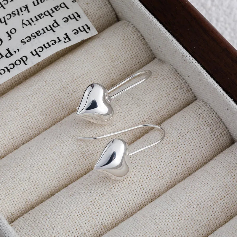 Korean-style glossy silver heart earrings with three-dimensional design and heart-shaped hooks