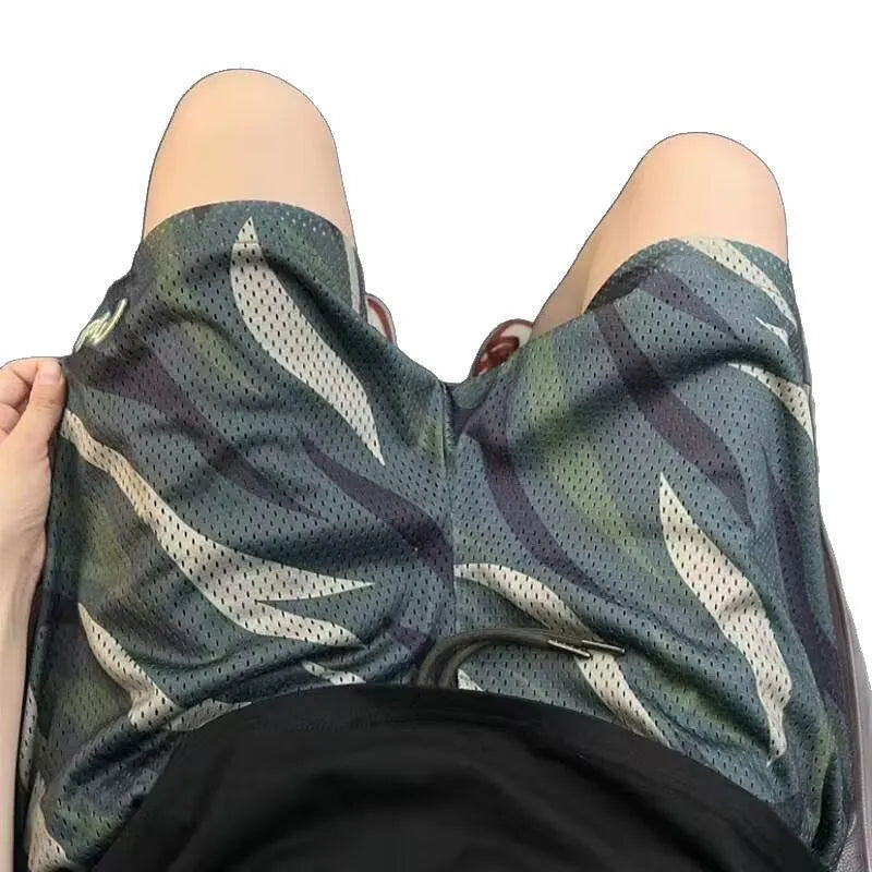 Men's straight leg camouflage mesh shorts in cotton blend fabric on a mannequin