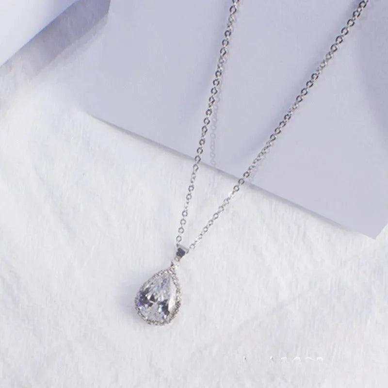 Women's water drop shaped pink necklace with rose gold rhinestone geometric detailing on alloy chain