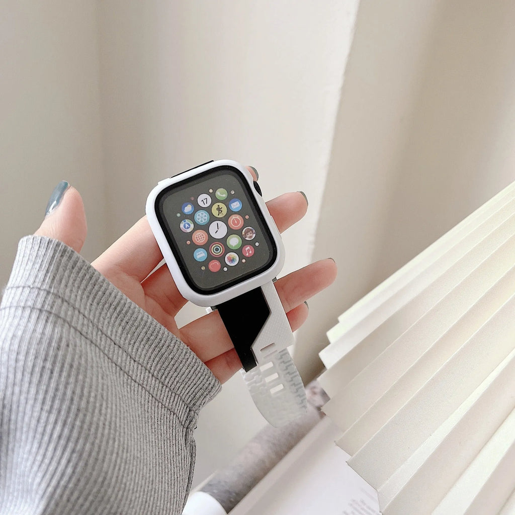 Two-tone silicone protective case for Apple Watch in black and white on a flat surface